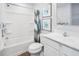 Bright bathroom with a shower-tub combo, modern vanity, and fresh, clean design elements at 634 Silverado Sunset Loop, Wendell, NC 27591