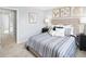 Cozy bedroom features soft, natural light, neutral tones, and comfortable striped bedding at 634 Silverado Sunset Loop, Wendell, NC 27591