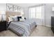 Bright bedroom with a large window, stylish decor, and plush bedding for a relaxing retreat at 634 Silverado Sunset Loop, Wendell, NC 27591