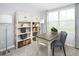 Inviting home office with a bookshelf, basket storage, and a well-lit work area by the window at 634 Silverado Sunset Loop, Wendell, NC 27591