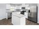 Bright kitchen with white cabinets, stainless steel appliances, granite countertops, and a functional center island at 634 Silverado Sunset Loop, Wendell, NC 27591