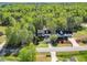 Beautiful aerial view of a home with mature trees, a driveway, and a well-maintained lawn on a quiet street at 7221 Messenger Dr, Willow Springs, NC 27592