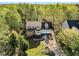 Aerial view of a traditional two-story home with a three-car garage, landscaped yard and a welcoming front porch at 7221 Messenger Dr, Willow Springs, NC 27592