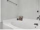 Clean bathroom featuring a white bathtub, modern fixtures, and minimalist decor at 7221 Messenger Dr, Willow Springs, NC 27592