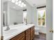 Bathroom featuring a double sink vanity, wood cabinets, and natural lighting at 7221 Messenger Dr, Willow Springs, NC 27592