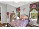 Charming bedroom showcasing a comfortable bed, dresser, and natural light from windows at 7221 Messenger Dr, Willow Springs, NC 27592
