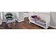 Bedroom with a crib, rocking chair, and hardwood floors creates a serene and comfortable atmosphere at 7221 Messenger Dr, Willow Springs, NC 27592