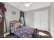 Comfortable bedroom featuring a large window with a view of the backyard and a charming bed at 7221 Messenger Dr, Willow Springs, NC 27592