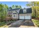 Charming two-story home with a two car garage, landscaped yard, and front porch at 7221 Messenger Dr, Willow Springs, NC 27592