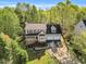 Aerial shot of a tan home with a two-car garage, a lovely lawn and mature trees for privacy and shade at 7221 Messenger Dr, Willow Springs, NC 27592