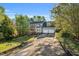 Beautiful home with a long drive, two-car garage and front porch nestled in a wooded lot at 7221 Messenger Dr, Willow Springs, NC 27592