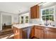 A sunlit kitchen featuring a wooden table, stainless steel appliances, and ample cabinet space at 7221 Messenger Dr, Willow Springs, NC 27592