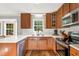 Efficient kitchen design boasting wooden cabinets, stainless steel appliances, a sink under the window, and modern countertops at 7221 Messenger Dr, Willow Springs, NC 27592