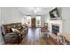 Inviting living room with fireplace, hardwood floors, and comfortable seating at 7221 Messenger Dr, Willow Springs, NC 27592