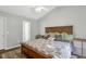 Bright bedroom with a wooden bed, ample natural light, and calming color palette at 7221 Messenger Dr, Willow Springs, NC 27592