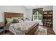 Inviting primary bedroom with a cozy bed, reading nook, and neutral color scheme at 7221 Messenger Dr, Willow Springs, NC 27592