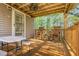 Cozy wooden porch with rocking chairs and ceiling fan, ideal for relaxing outdoors at 7221 Messenger Dr, Willow Springs, NC 27592