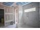 Bright bathroom featuring a spacious shower with marble tile and natural light at 7436 Summer Tanager Trl, Raleigh, NC 27614