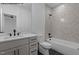 This bathroom offers a modern vanity, toilet, and a tub with beautiful designer tile in the shower at 7436 Summer Tanager Trl, Raleigh, NC 27614