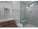 The bathroom boasts a stylish vanity, toilet, and a shower with blue textured tile at 7436 Summer Tanager Trl, Raleigh, NC 27614