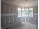 A bedroom is under construction, featuring a corner window, unfinished drywall, and exposed flooring at 7436 Summer Tanager Trl, Raleigh, NC 27614