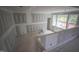 Interior view of a room under construction featuring drywall, natural light from windows, and unfinished floors at 7436 Summer Tanager Trl, Raleigh, NC 27614