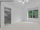 Bright bedroom featuring a large window and a closet, providing ample space at 7436 Summer Tanager Trl, Raleigh, NC 27614
