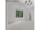Spacious bedroom with vaulted ceiling, plush carpet and statement chandelier at 7436 Summer Tanager Trl, Raleigh, NC 27614