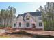 View of home in construction phase against the backdrop of tall trees at 7436 Summer Tanager Trl, Raleigh, NC 27614