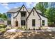 Front exterior showcasing beautiful brickwork, dark trim, and manicured landscaping at 7436 Summer Tanager Trl, Raleigh, NC 27614