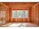Interior view of home during framing stage showing window placement and wall studs at 7436 Summer Tanager Trl, Raleigh, NC 27614