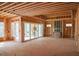 Open-concept living space during construction showing framing, sliding glass doors, and fireplace at 7436 Summer Tanager Trl, Raleigh, NC 27614