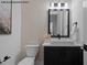 Modern half bathroom featuring black fixtures, stylish decor, and a sleek vanity at 7436 Summer Tanager Trl, Raleigh, NC 27614