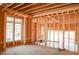 Unfinished interior view with light-filled rooms framed by wooden studs at 7436 Summer Tanager Trl, Raleigh, NC 27614