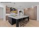 Kitchen featuring a large island, pendant lights, and wooden cabinets at 7436 Summer Tanager Trl, Raleigh, NC 27614
