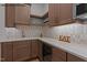 Kitchen area featuring stylish tile backsplash, countertop space, and wood cabinets at 7436 Summer Tanager Trl, Raleigh, NC 27614