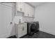 Laundry room featuring a sink, cabinetry, washer, and dryer at 7436 Summer Tanager Trl, Raleigh, NC 27614