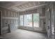 Large living area under construction showcasing potential views from large windows at 7436 Summer Tanager Trl, Raleigh, NC 27614