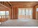 Unfinished living room featuring sliding glass doors leading to a porch and providing natural light and outdoor access at 7436 Summer Tanager Trl, Raleigh, NC 27614