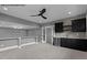 Spacious room featuring a wet bar with mini-fridge and sink with modern fixtures at 7436 Summer Tanager Trl, Raleigh, NC 27614
