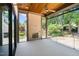 Inviting covered patio featuring a fireplace and a wood ceiling, perfect for outdoor relaxation at 7436 Summer Tanager Trl, Raleigh, NC 27614
