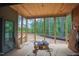 Outdoor porch under construction with a view of the trees and a table saw in the foreground at 7436 Summer Tanager Trl, Raleigh, NC 27614