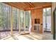 Unfinished porch featuring a fireplace and a view of the surrounding wooded landscape at 7436 Summer Tanager Trl, Raleigh, NC 27614
