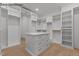 Spacious walk-in closet with custom shelving, drawers, and center island for ample storage at 7436 Summer Tanager Trl, Raleigh, NC 27614