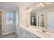 A bathroom features a double vanity with white countertops, a large mirror, and an enclosed shower at 748 Swim Cave Ln, Wendell, NC 27591