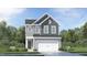 Charming two-story home with gray siding, a two-car garage, and a beautifully landscaped front yard at 748 Swim Cave Ln, Wendell, NC 27591