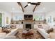 Bright living room with exposed wood beams, fireplace, and neutral decor at 749 Golfers Vw, Pittsboro, NC 27312