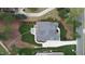 Aerial view of a beautifully landscaped home with a patio area and lush greenery at 749 Golfers Vw, Pittsboro, NC 27312