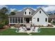 Spacious backyard featuring a fire pit, outdoor seating, and a screened-in porch at 749 Golfers Vw, Pittsboro, NC 27312