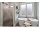 Bright bathroom featuring soaking tub next to walk-in shower with marble tile and rain shower head at 749 Golfers Vw, Pittsboro, NC 27312
